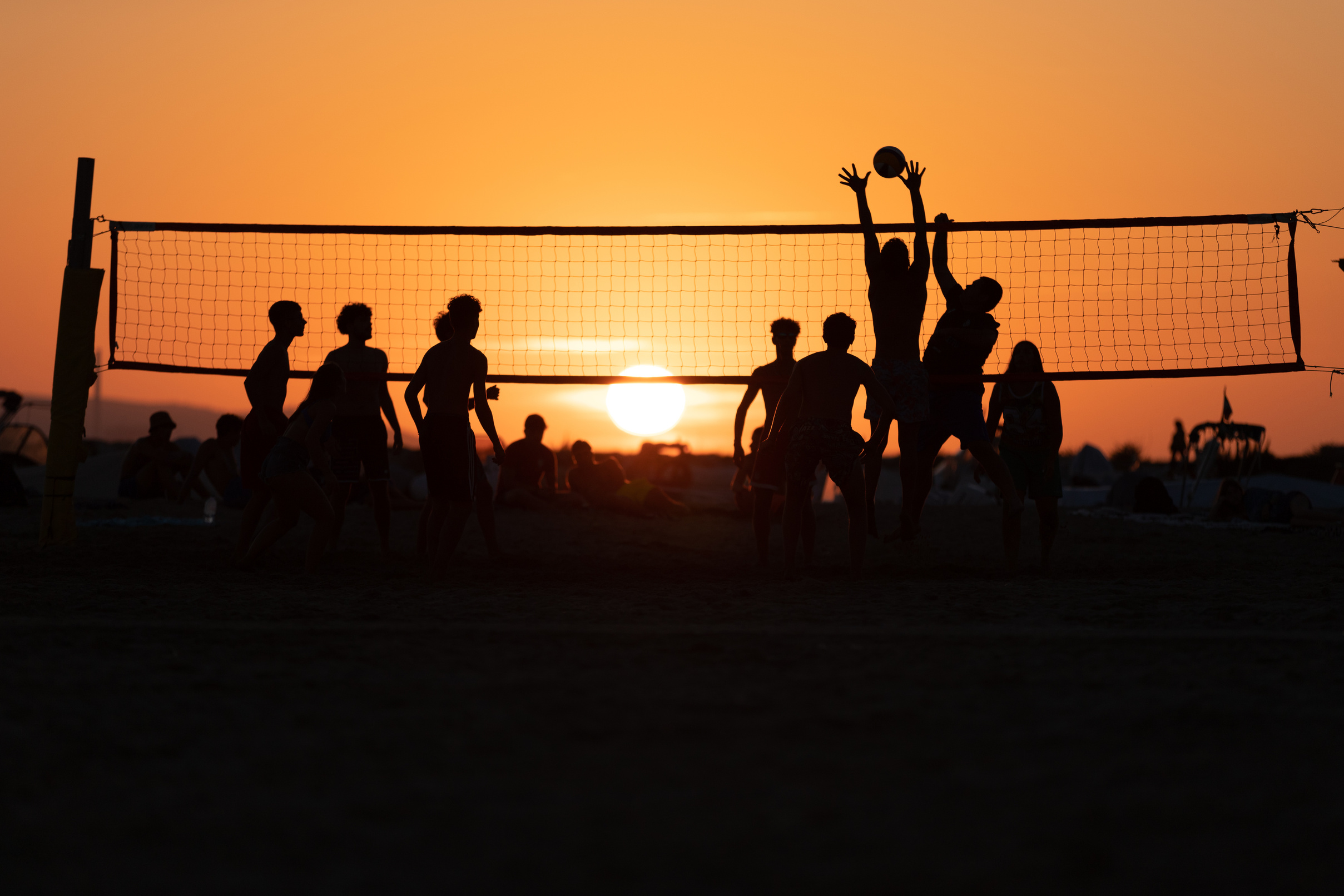 Silhouette of People Playing Volleyball during Sunset