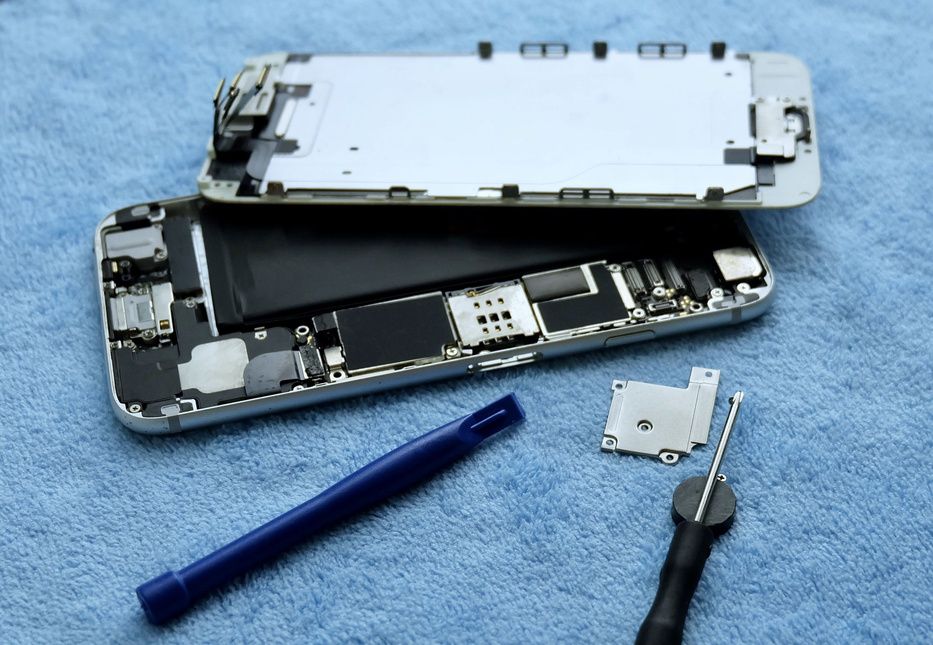 Person Repairing Smartphone with A Screwdriver